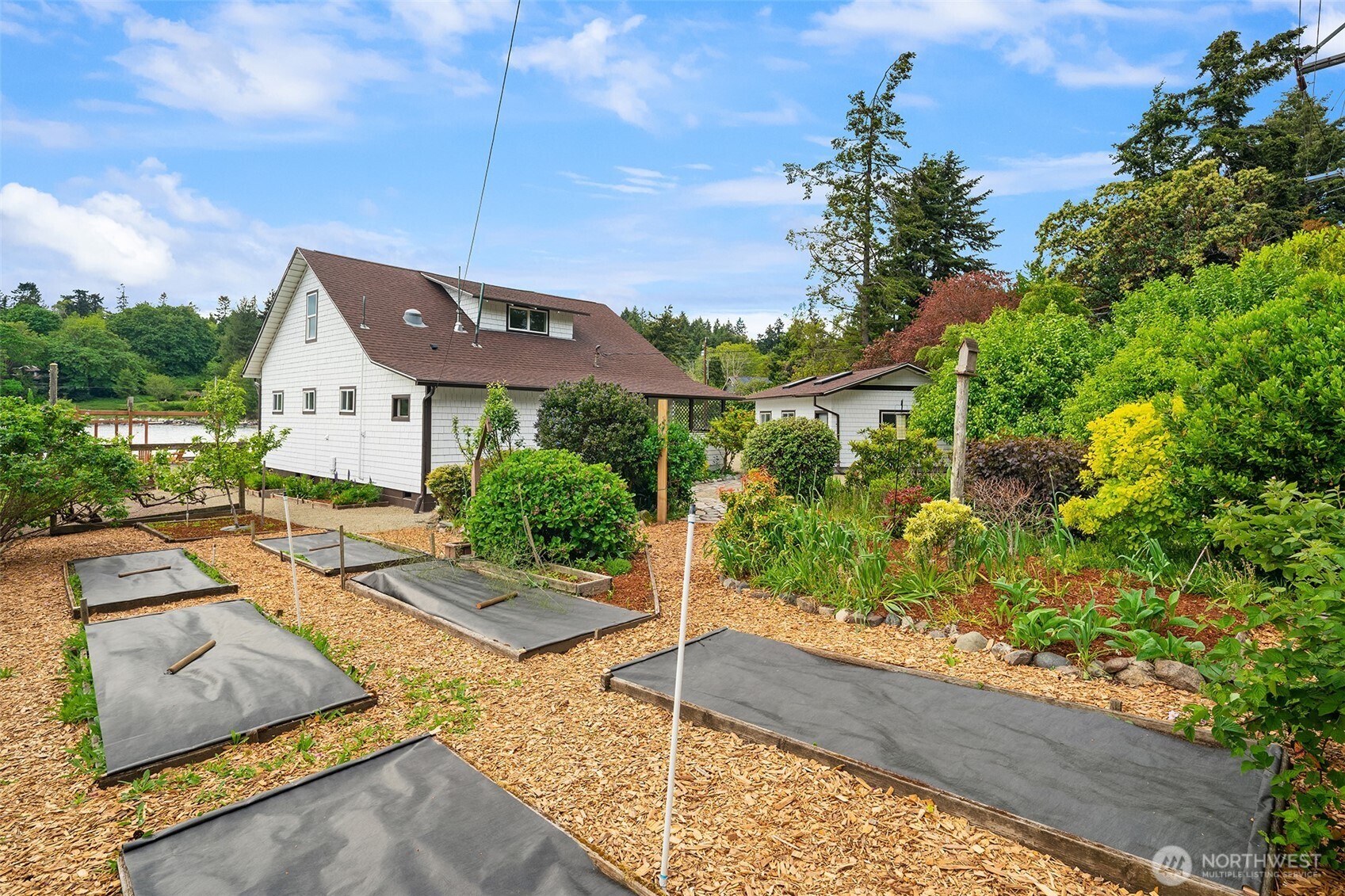 22113 Dockton Road Southwest Vashon, WA 98070 - Photo 9 of 40 a front view of a house with garden