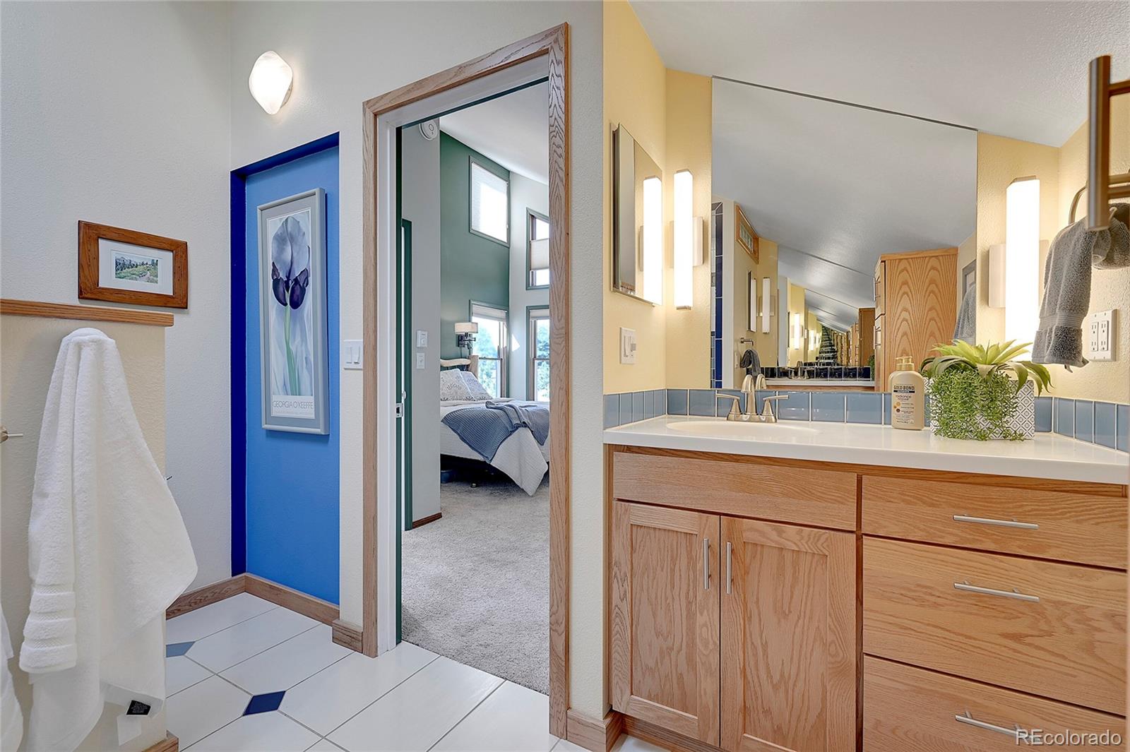 63 Plains View Road Boulder, CO 80302 - Photo 26 of 48 a en suite bathroom with a sink a mirror a vanity and a shower