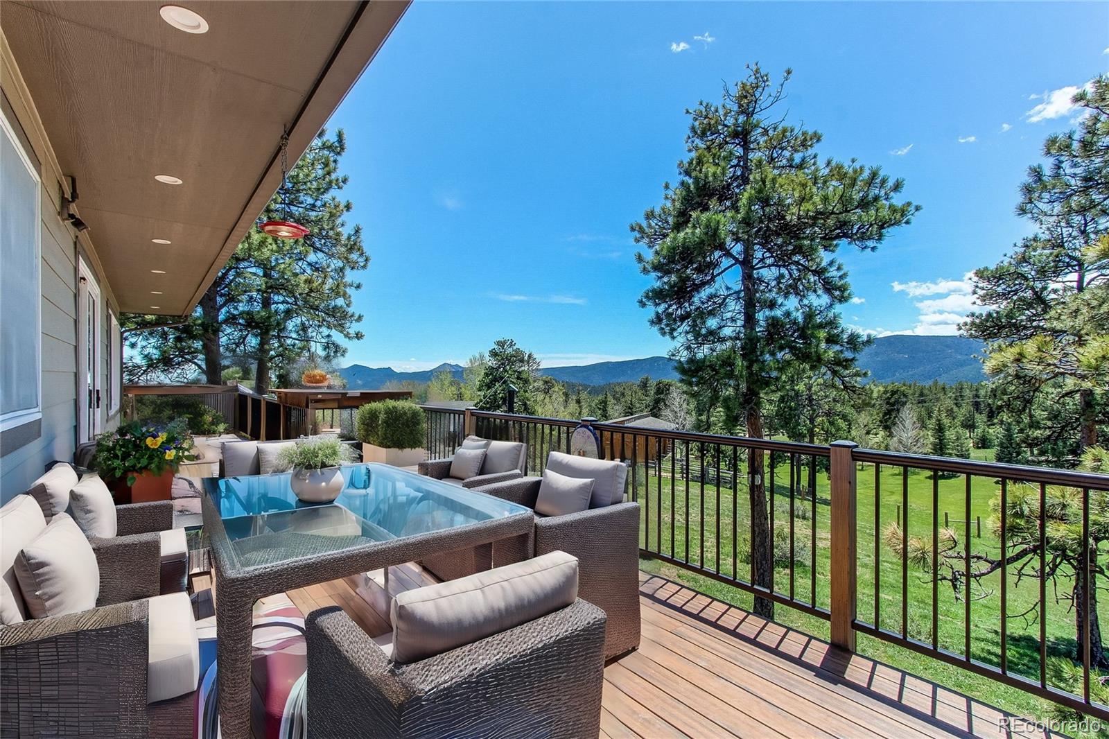 63 Plains View Road Boulder, CO 80302 - Photo 3 of 48 a view of a balcony with couches and wooden floor