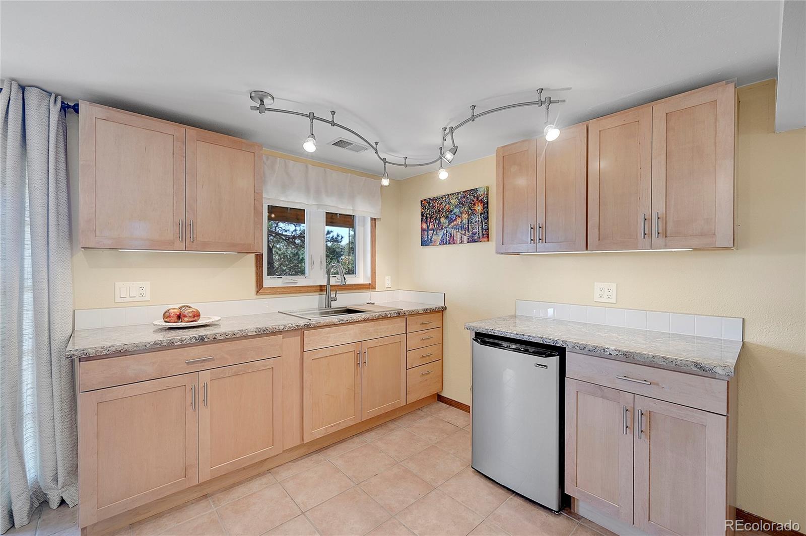 63 Plains View Road Boulder, CO 80302 - Photo 37 of 48 a kitchen with white cabinets sink and stove