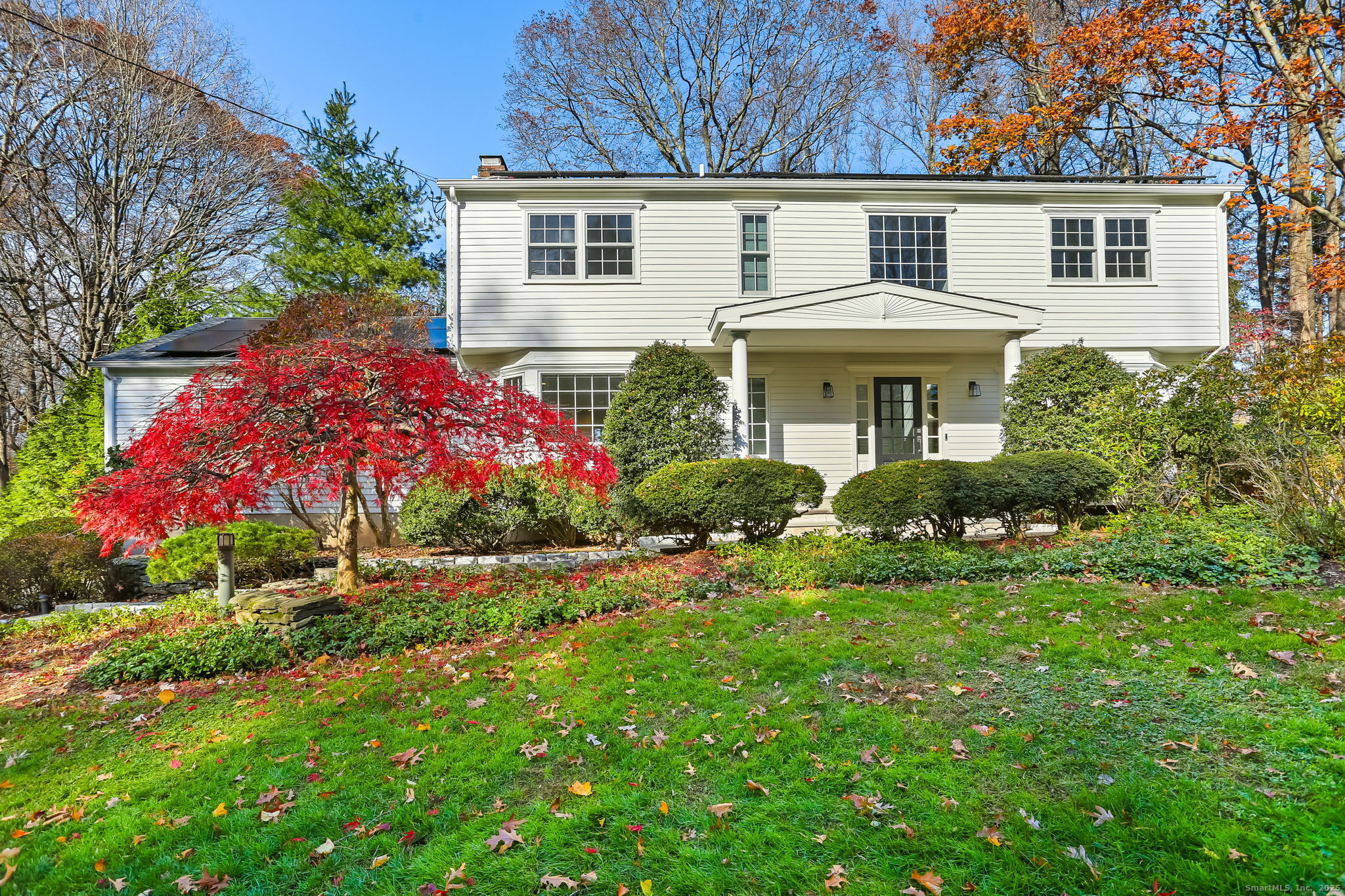 5 Willow Walk Road Westport, CT 06880 - Photo 2 of 40 a front view of a house with a yard and garage