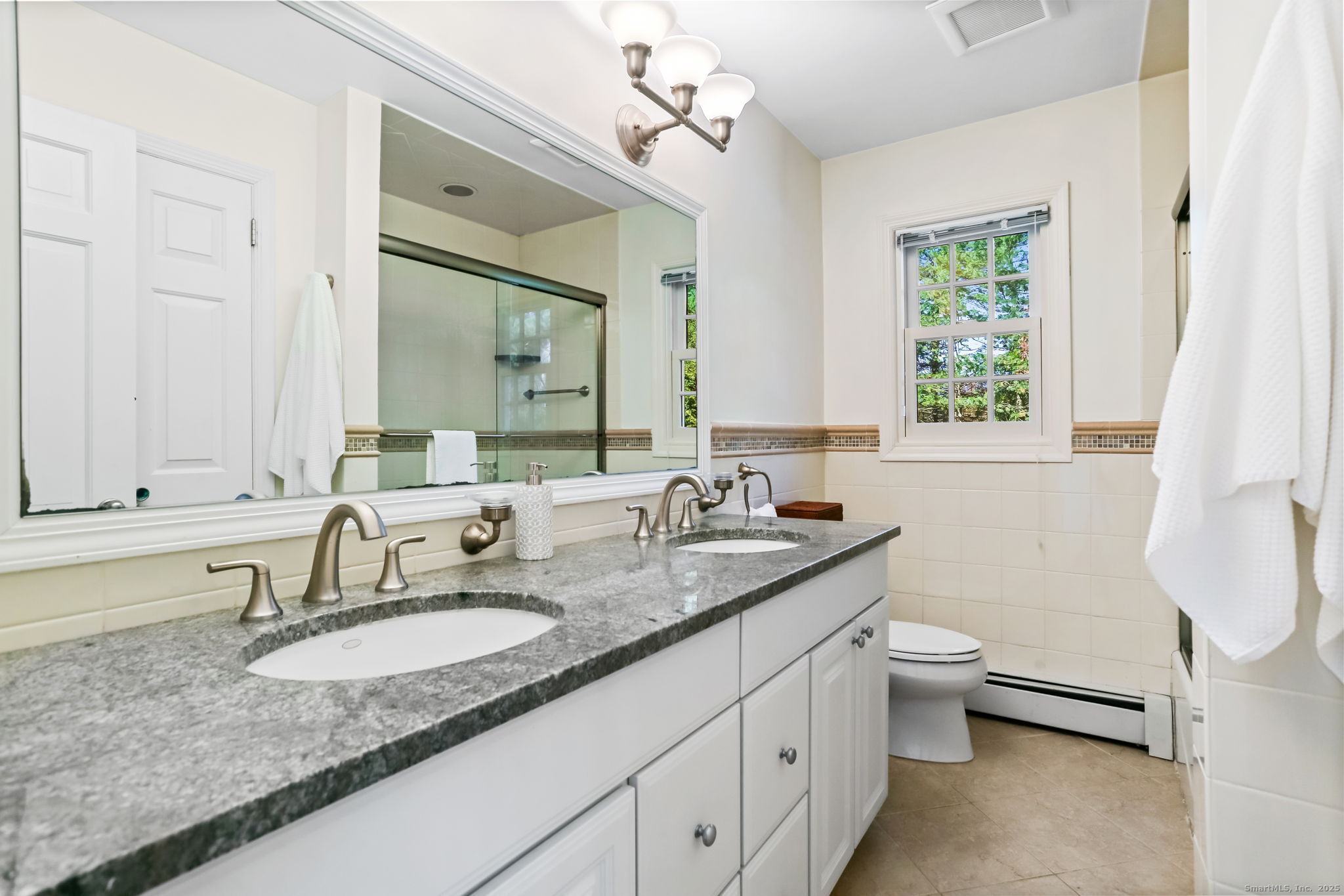 5 Willow Walk Road Westport, CT 06880 - Photo 28 of 40 a bathroom with a granite countertop sink a toilet and mirror