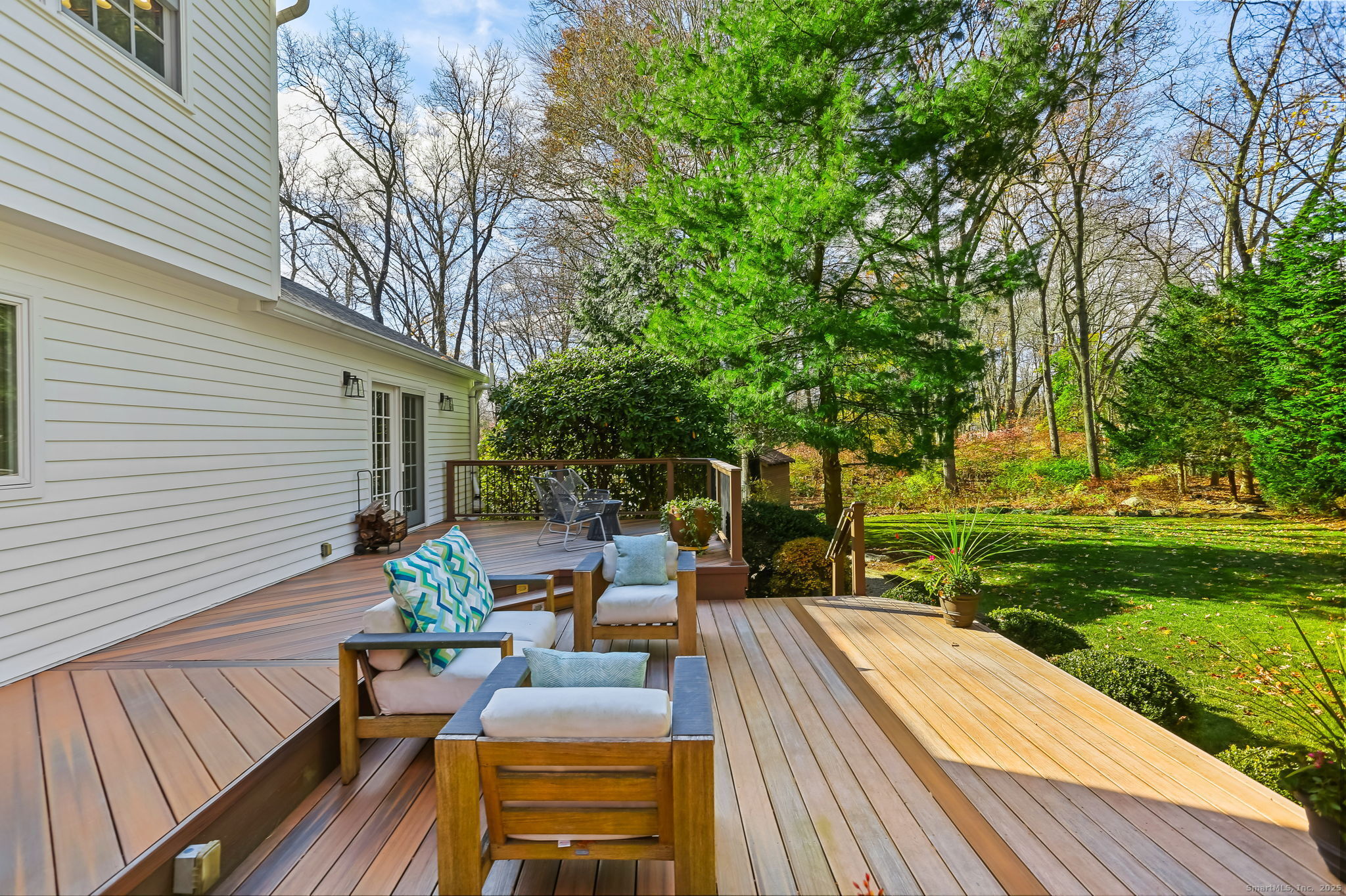5 Willow Walk Road Westport, CT 06880 - Photo 34 of 40 a view of a patio with dining table and chairs with wooden floor and fence