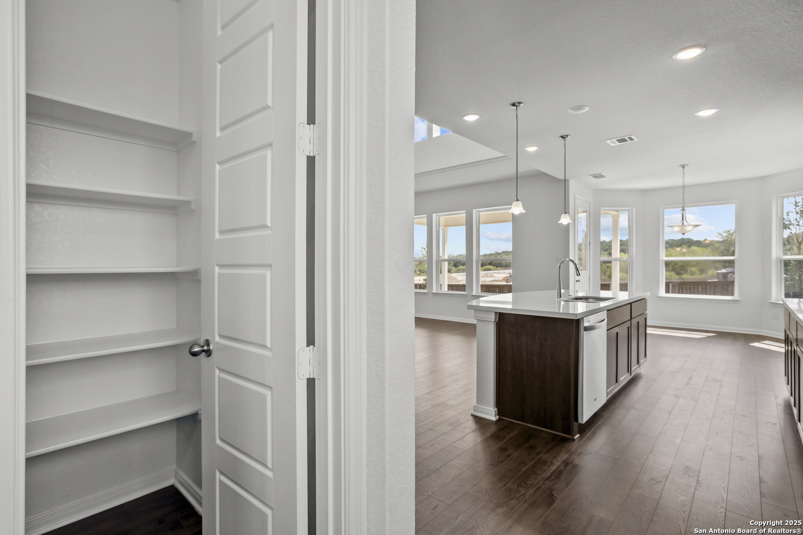 2804 Reeves Lane Schertz, TX 78108 - Photo 11 of 44 a kitchen with kitchen island white cabinets and appliances