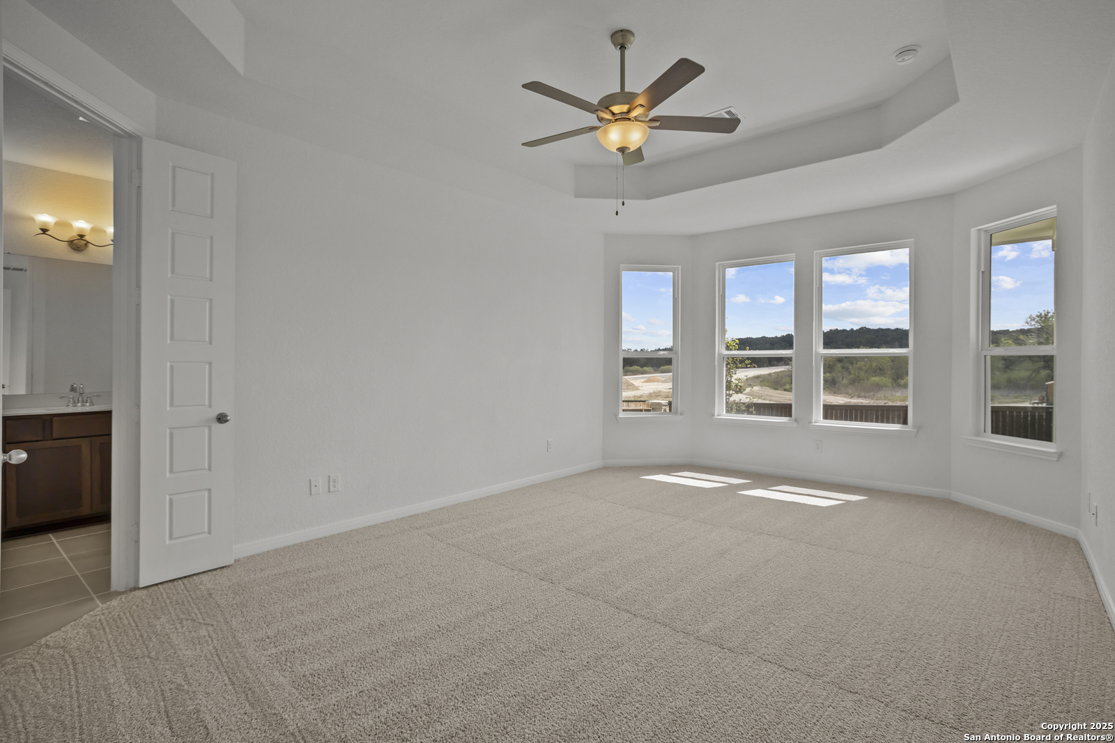 2804 Reeves Lane Schertz, TX 78108 - Photo 21 of 44 an empty room with windows and fan