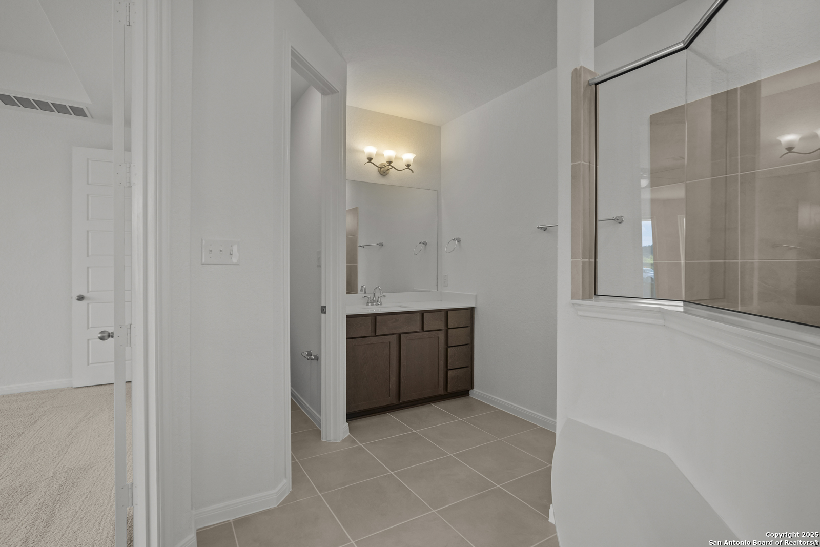 2804 Reeves Lane Schertz, TX 78108 - Photo 25 of 44 a bathroom with a granite countertop sink a toilet and mirror