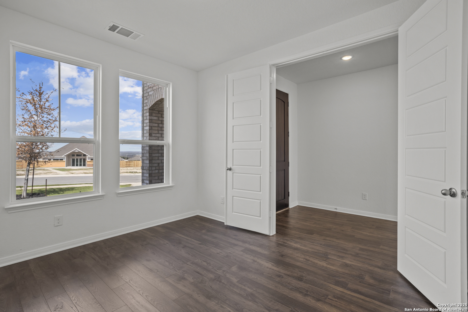 2804 Reeves Lane Schertz, TX 78108 - Photo 6 of 44 an empty room with wooden floor and windows