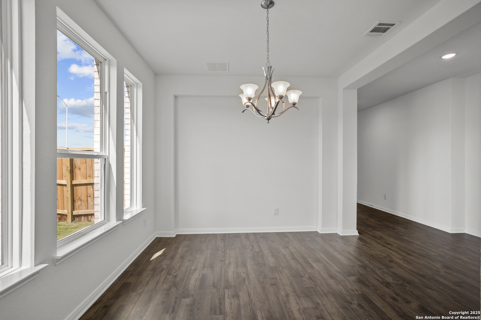 2804 Reeves Lane Schertz, TX 78108 - Photo 9 of 44 a view of livingroom with chandelier and wooden floor