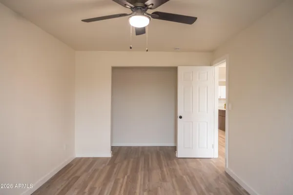 a view of an empty room and wooden floor