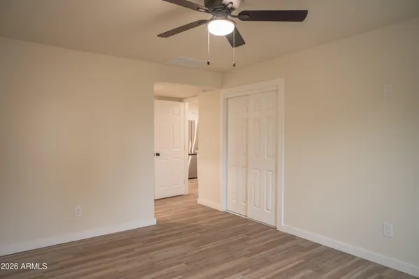 a view of an empty room and wooden floor