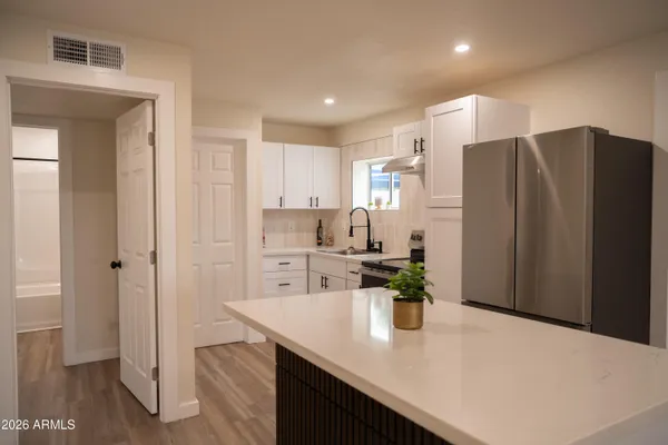 a kitchen with stainless steel appliances a refrigerator and microwave