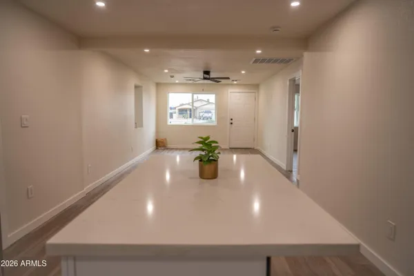a kitchen with stainless steel appliances a refrigerator a sink a counter top space