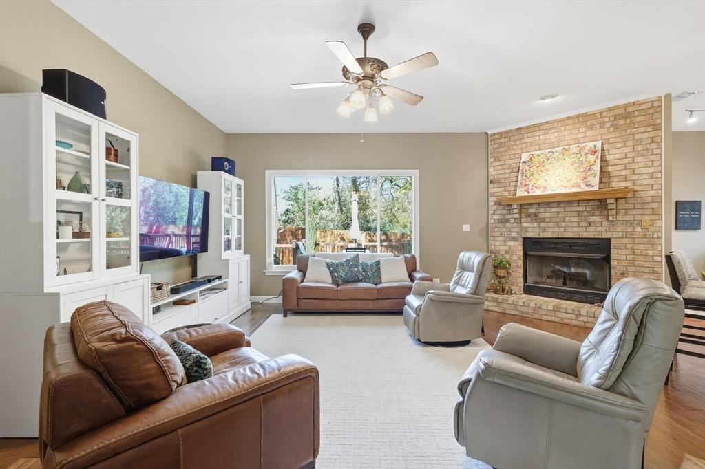 1311 Wilderness Street Denton, TX 76205 - Photo 11 of 40 a living room with furniture and a fireplace