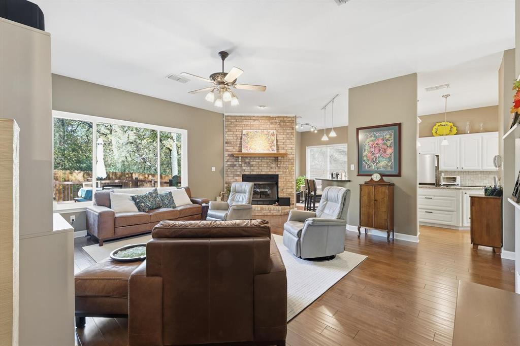1311 Wilderness Street Denton, TX 76205 - Photo 12 of 40 a living room with fireplace furniture and a large window