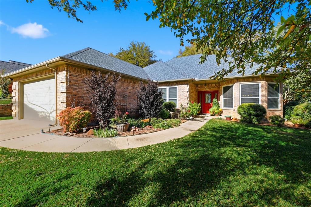 1311 Wilderness Street Denton, TX 76205 - Photo 2 of 40 a front view of a house with a yard