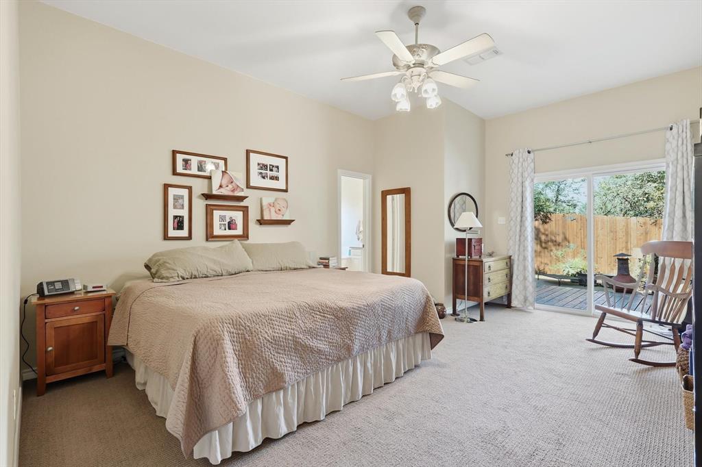 1311 Wilderness Street Denton, TX 76205 - Photo 22 of 40 a bedroom with a bed a couch and a large window