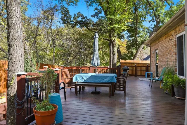 a backyard of a house with barbeque oven table and chairs