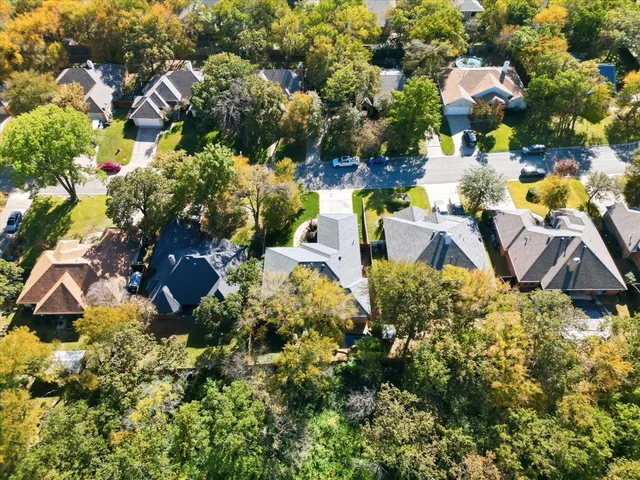 a aerial view of a house with a yard and lake view
