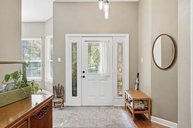 a view of a room that has a bed and a window in it