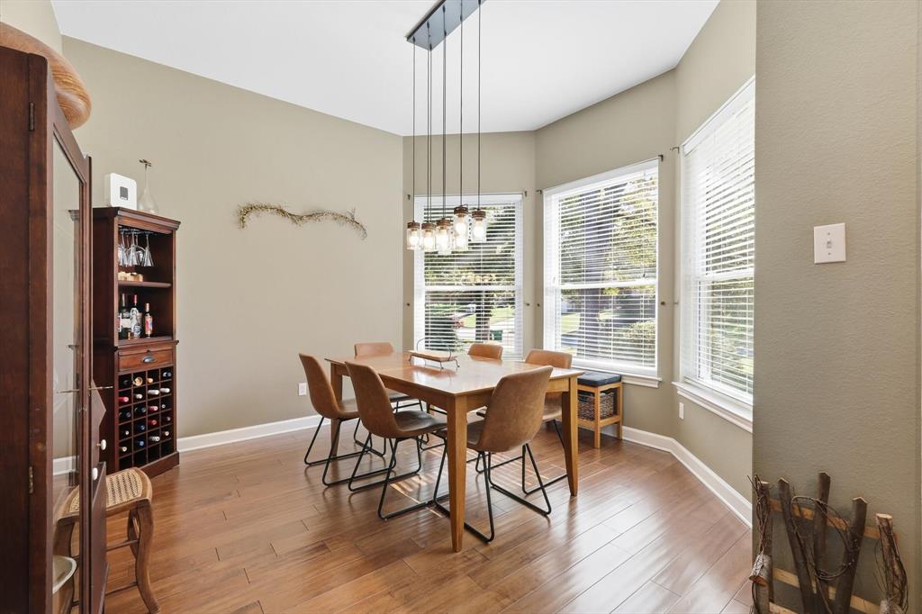 1311 Wilderness Street Denton, TX 76205 - Photo 5 of 40 a view of a dining room with furniture window and wooden floor