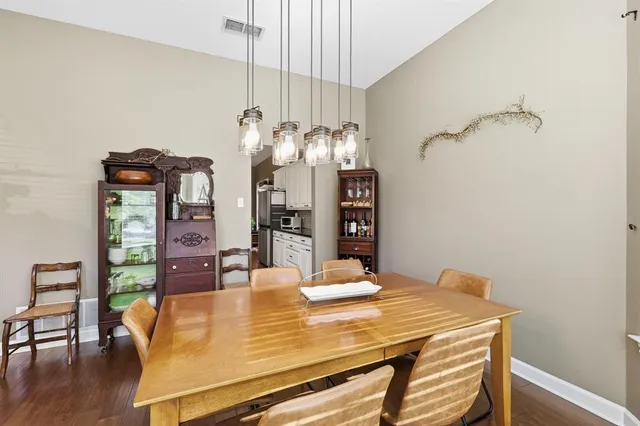 a dining room with furniture and wooden floor