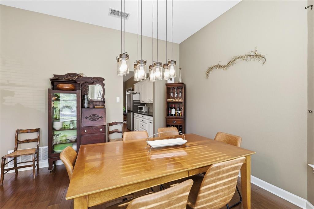 1311 Wilderness Street Denton, TX 76205 - Photo 6 of 40 a dining room with furniture and wooden floor
