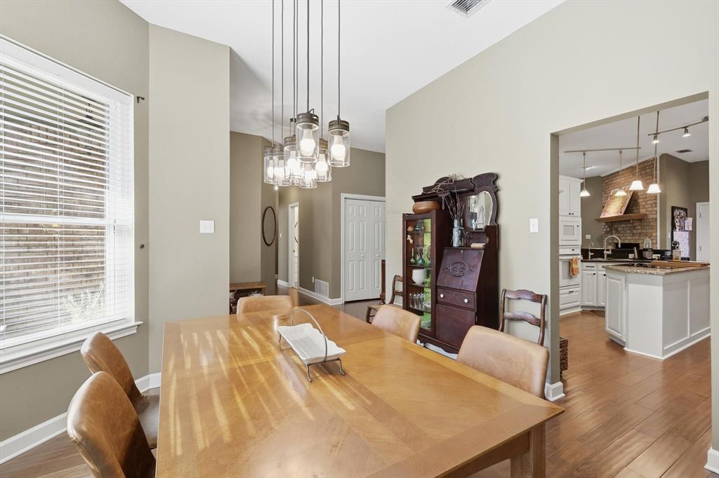 1311 Wilderness Street Denton, TX 76205 - Photo 7 of 40 a view of a dining room with furniture and wooden floor