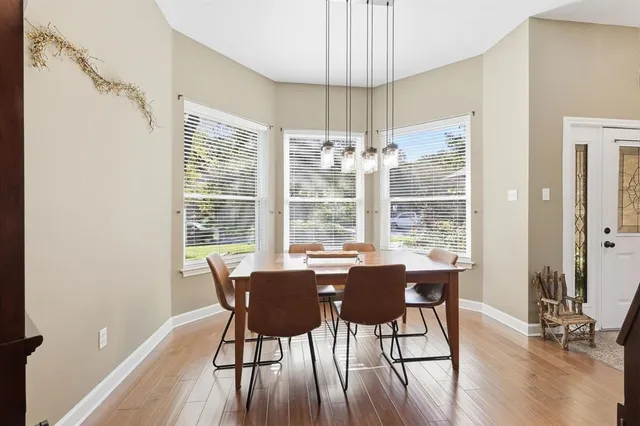 a view of a dining room with furniture window and wooden floor