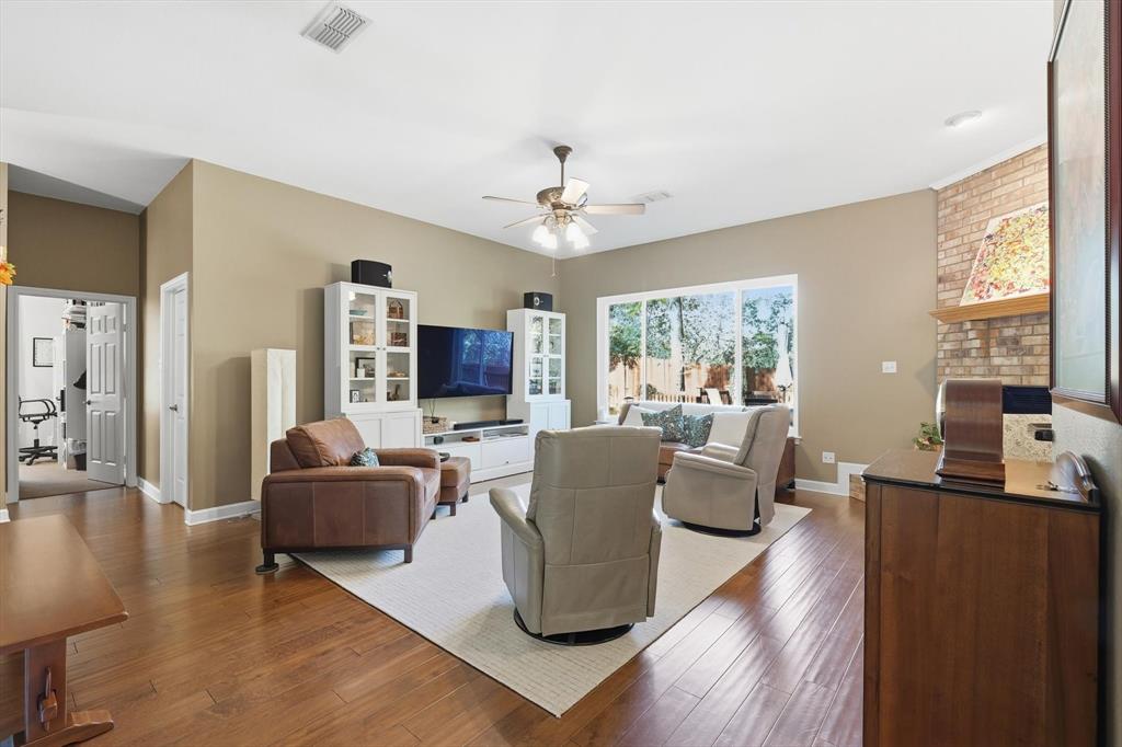 1311 Wilderness Street Denton, TX 76205 - Photo 10 of 40 a living room with fireplace furniture and a large window