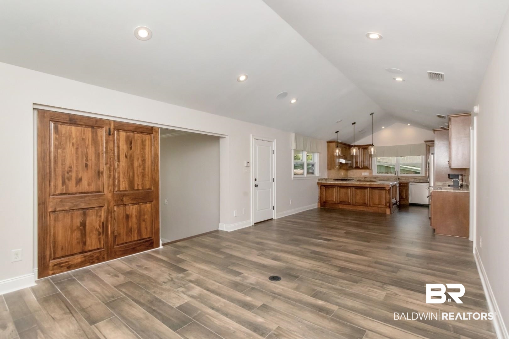 231 Rochester Road Mobile, AL 36608 - Photo 7 of 51 Unfurnished living room featuring dark wood-style floors and baseboards