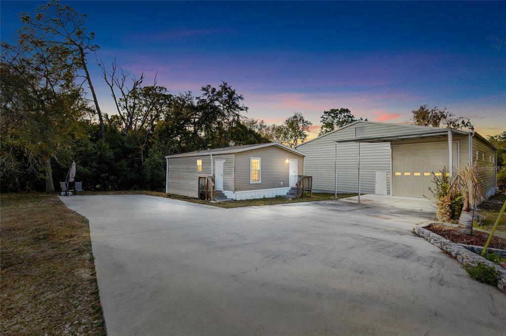 5937 Penny Royal Road Wesley Chapel, FL 33545 - Photo 1 of 1 a view of a house with a yard and garage