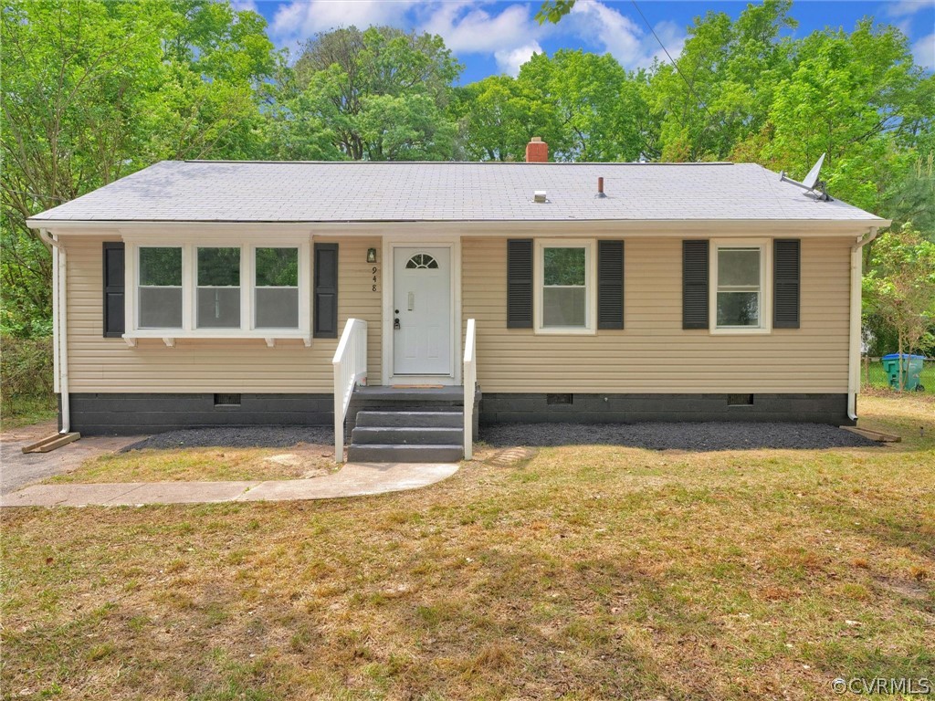 a view of house with backyard and sitting area
