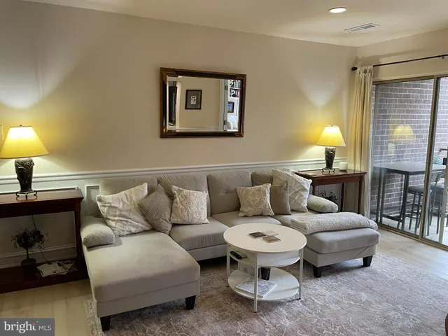 a living room with furniture and a lamp