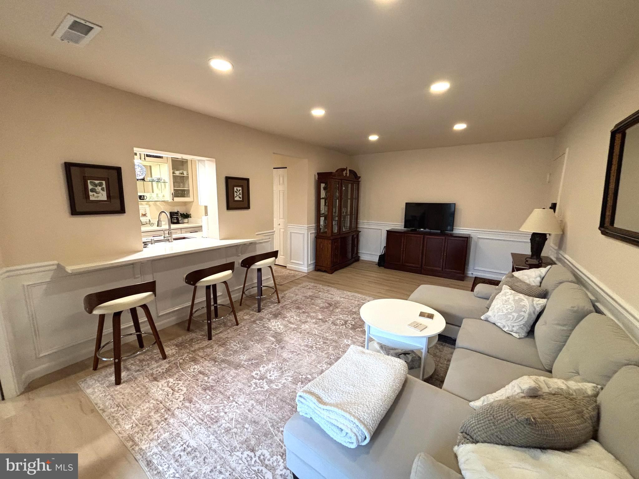8310 Tobin Road, Unit 21 Annandale, VA 22003 - Photo 5 of 24 a living room with furniture and a flat screen tv