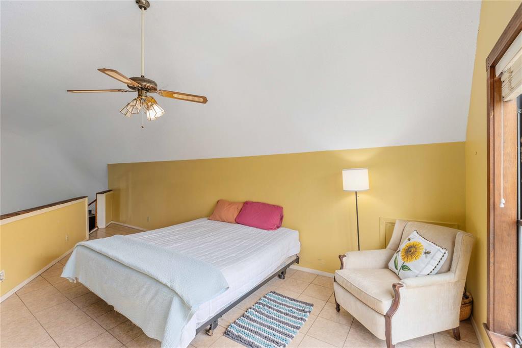 660 County Road 549 Mullin, TX 76864 - Photo 14 of 40 a bedroom with a bed and ceiling fan