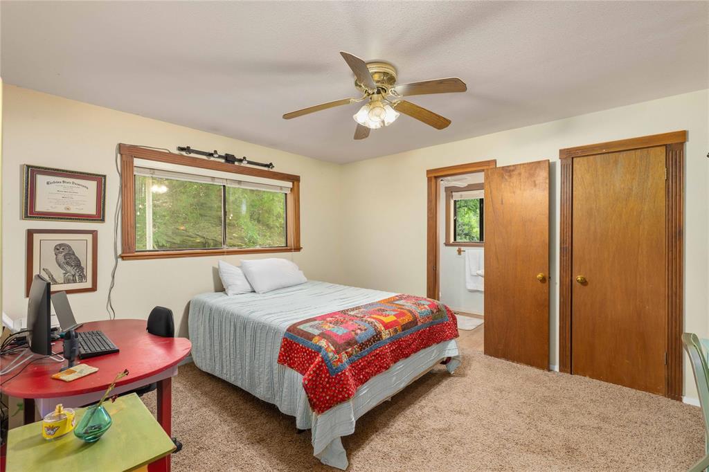 660 County Road 549 Mullin, TX 76864 - Photo 16 of 40 a bedroom with a bed a chandelier and dresser