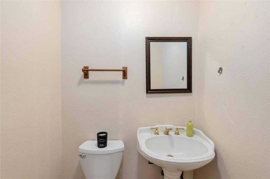 660 County Road 549 Mullin, TX 76864 - Photo 18 of 40 a bathroom with a toilet a sink and mirror
