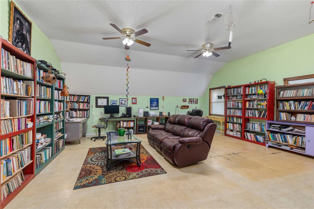 660 County Road 549 Mullin, TX 76864 - Photo 20 of 40 a living room with furniture and a book shelf