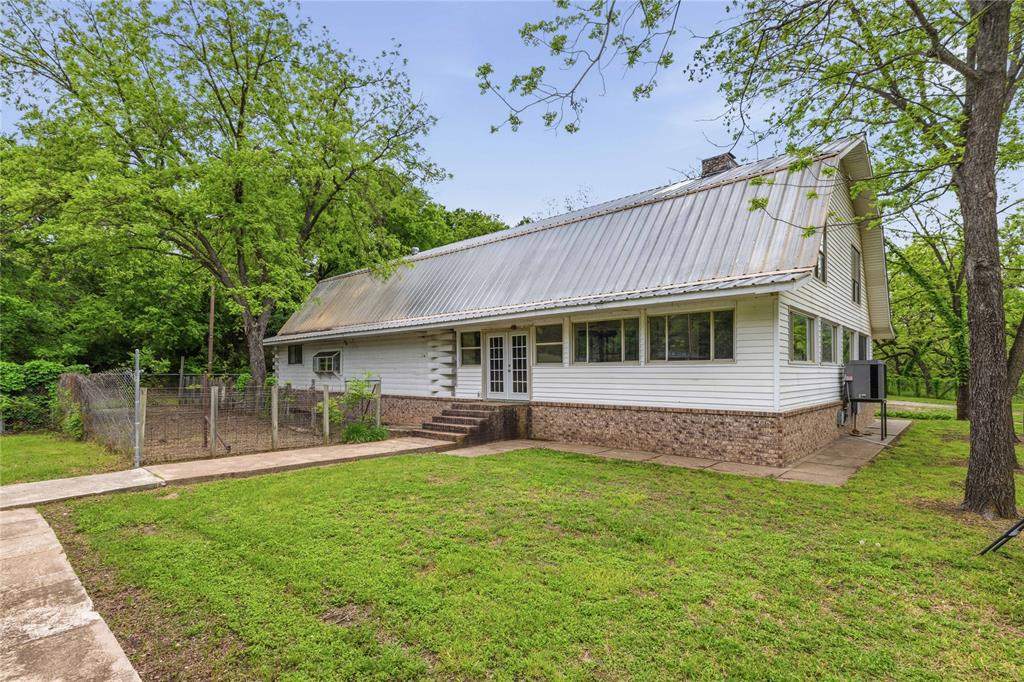 660 County Road 549 Mullin, TX 76864 - Photo 2 of 40 a front view of a house with a yard deck and outdoor seating
