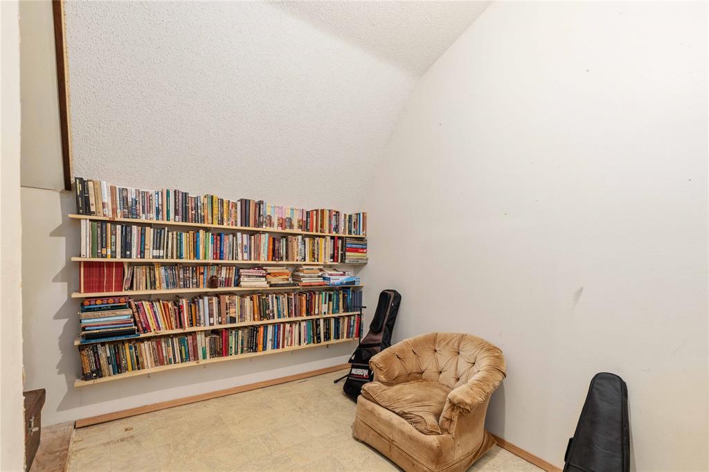 660 County Road 549 Mullin, TX 76864 - Photo 22 of 40 a living room with bookshelf and a book shelf