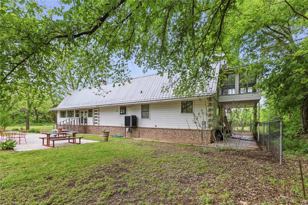 660 County Road 549 Mullin, TX 76864 - Photo 3 of 40 a front view of a house with a garden