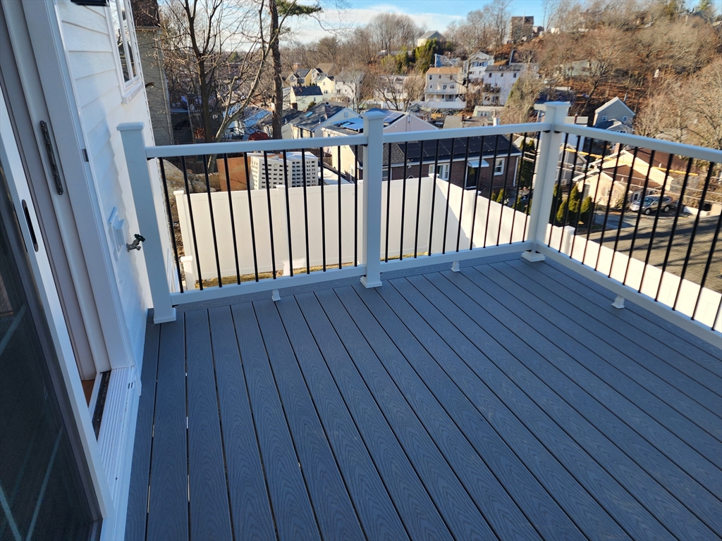 63 Montclair Avenue Waltham, MA 02451 - Photo 21 of 23 a balcony with wooden floor