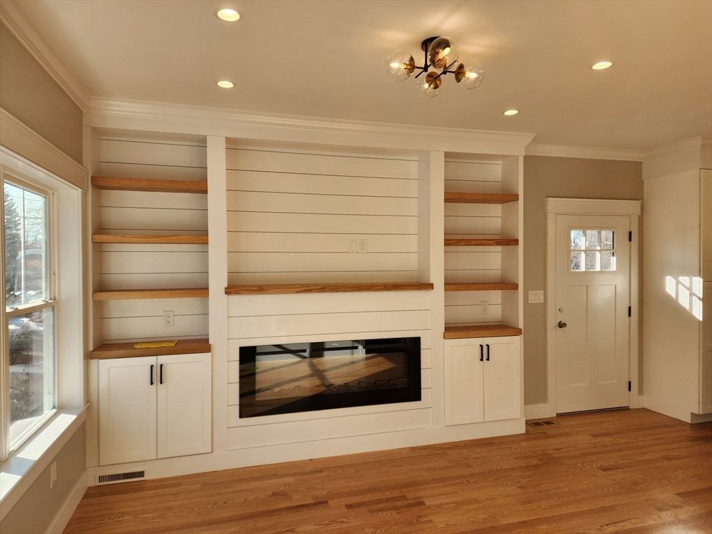 63 Montclair Avenue Waltham, MA 02451 - Photo 3 of 23 a view of a livingroom with an empty space & wooden floor