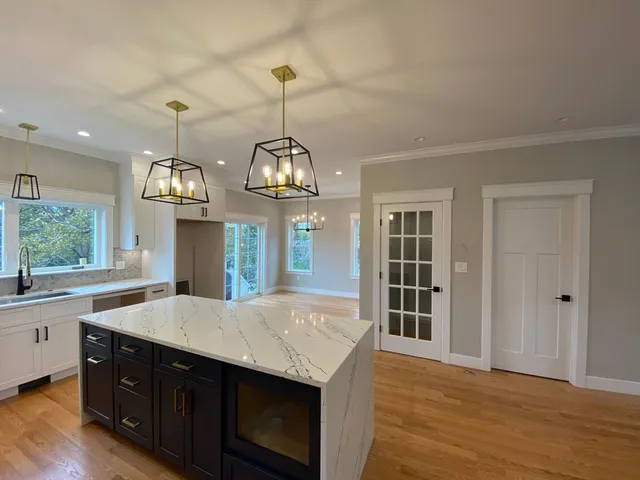 a kitchen with a stove and a wooden floors