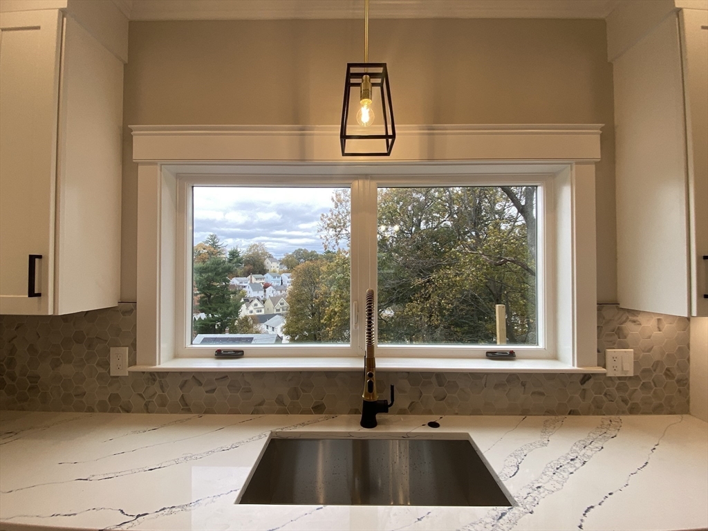 63 Montclair Avenue Waltham, MA 02451 - Photo 7 of 23 a front view of a house with a large window