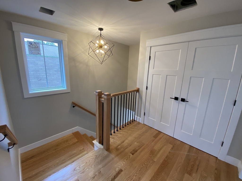 63 Montclair Avenue Waltham, MA 02451 - Photo 10 of 23 wooden floor in an empty room with a window