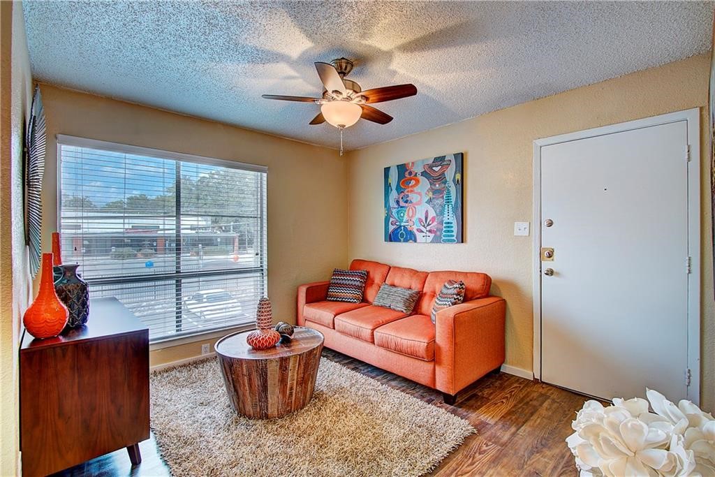 2401 Manor Road, Unit 112 Austin, TX 78722 - Photo 3 of 8 a living room with furniture and a window
