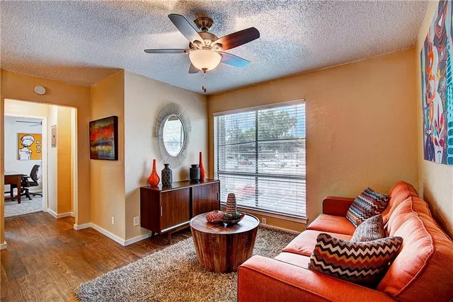 a living room with furniture a window and a chandelier