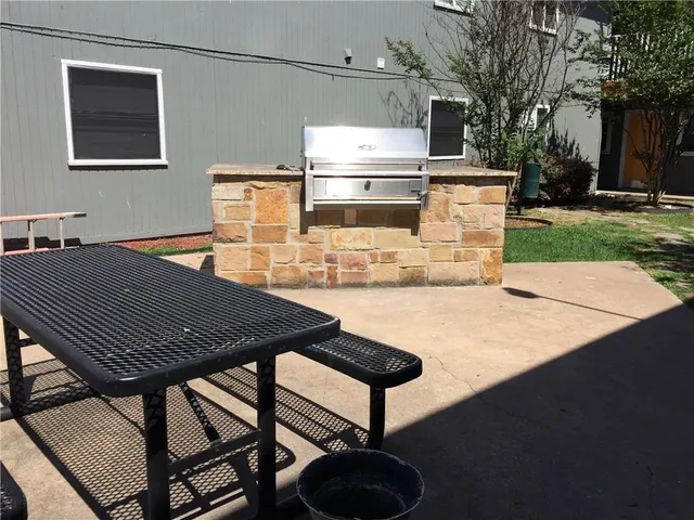 a backyard of a house with yard fire pit barbeque oven and outdoor seating