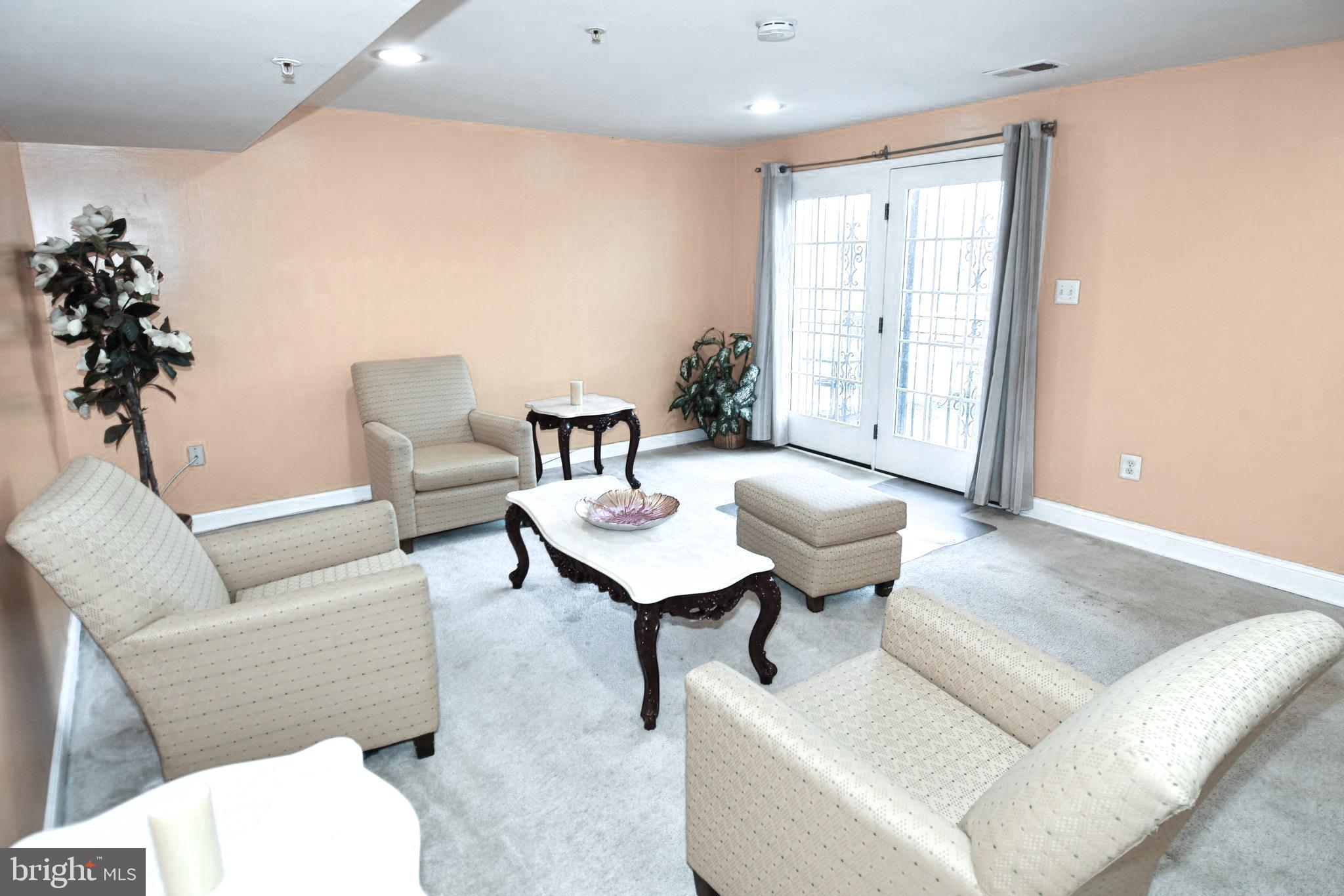 14528 Fairdale Road Silver Spring, MD 20905 - Photo 57 of 62 a living room with furniture and a potted plant